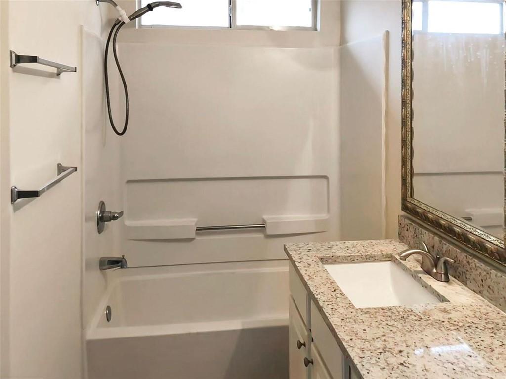 2568 Walden Lake Drive Decatur, GA 30035 - Photo 11 of 16 a bathroom with a granite countertop shower and a sink