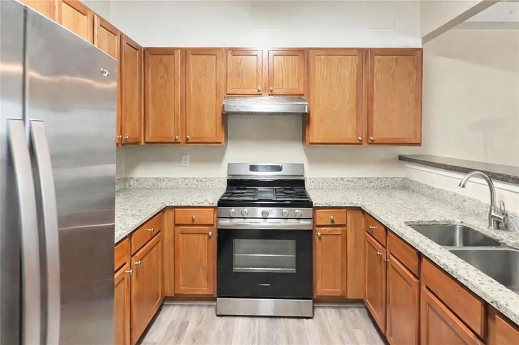 2568 Walden Lake Drive Decatur, GA 30035 - Photo 5 of 16 a kitchen with stainless steel appliances granite countertop a stove a sink and a refrigerator
