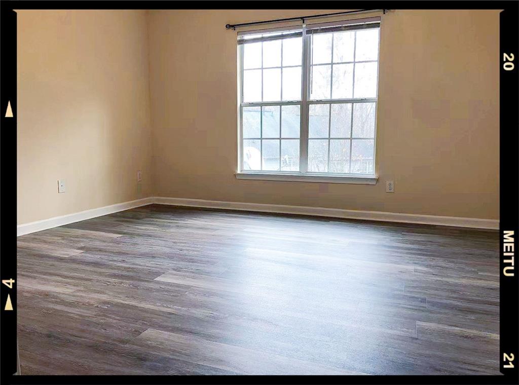 2568 Walden Lake Drive Decatur, GA 30035 - Photo 6 of 16 an empty room with wooden floor and windows