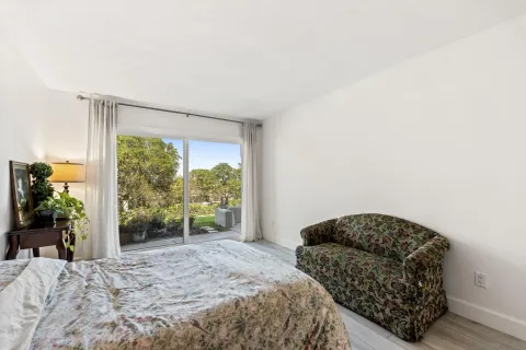 a bedroom with a bed and a potted plant