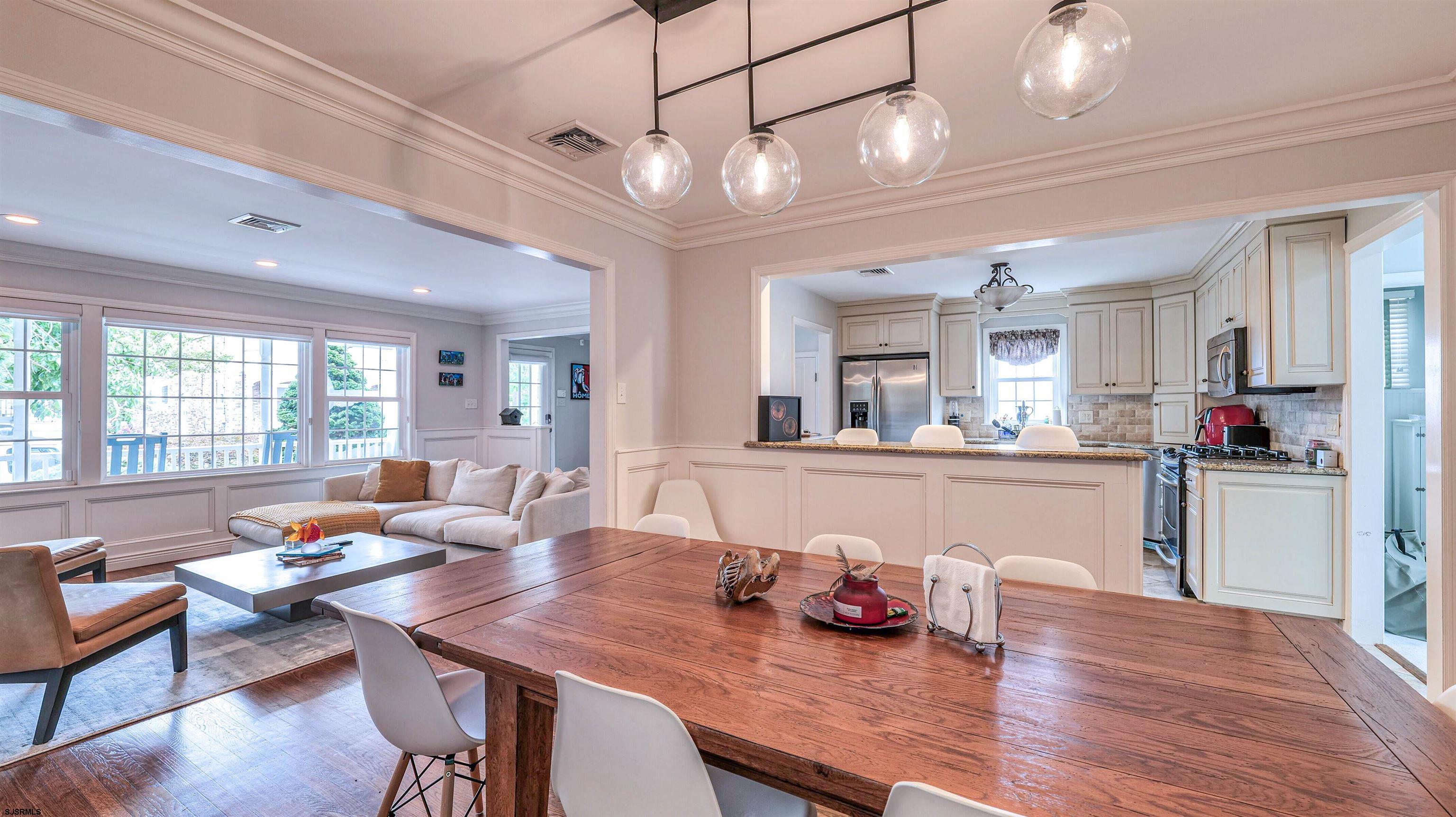 6 North Lancaster Avenue Margate City, NJ 08402 - Photo 12 of 32 a living room with kitchen island furniture and a chandelier
