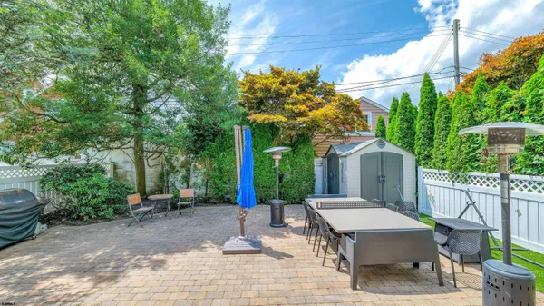 a view of backyard with a patio and outdoor seating