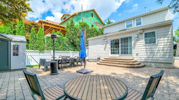a view of a patio with table and chairs and potted plants