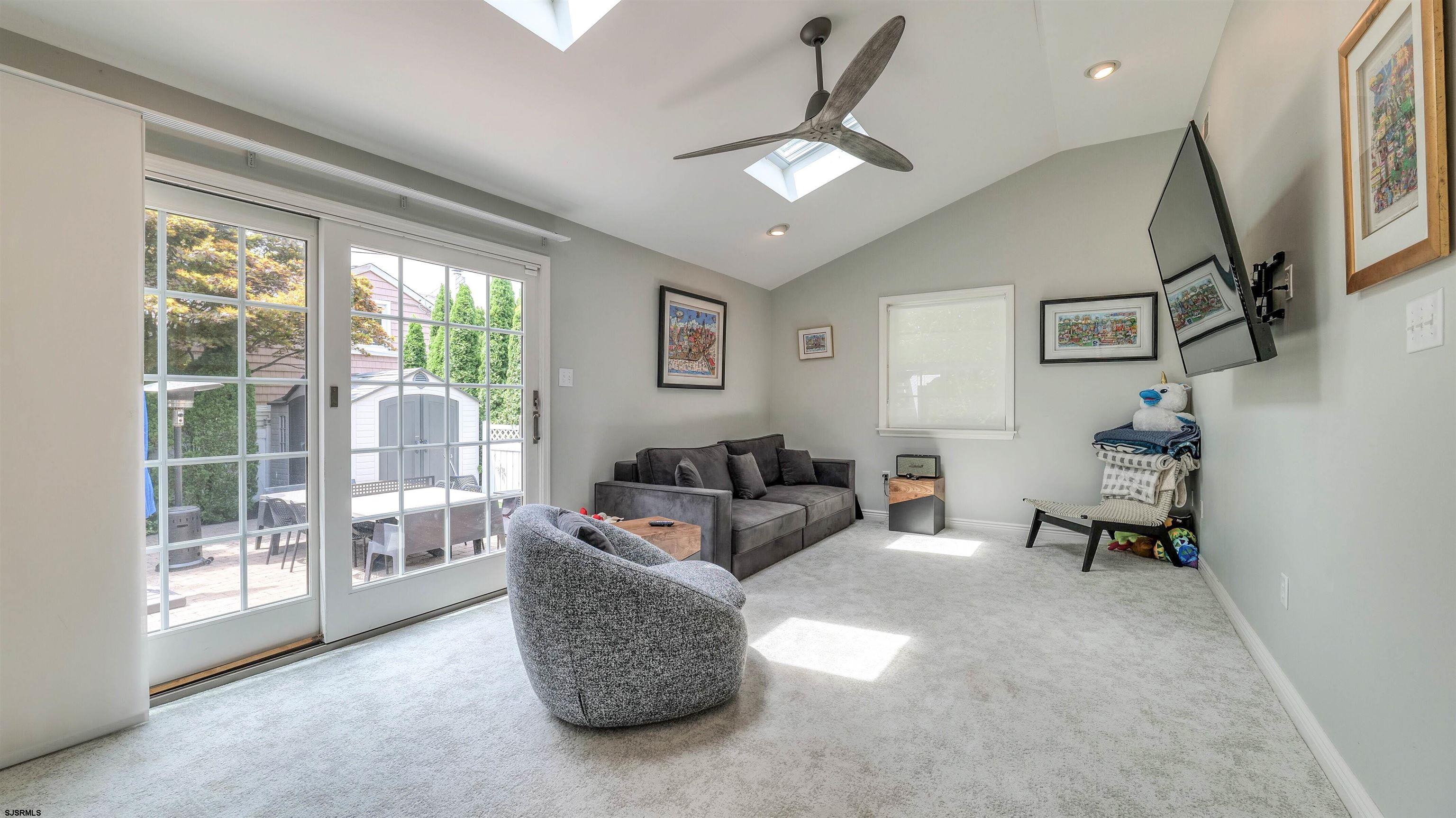 6 North Lancaster Avenue Margate City, NJ 08402 - Photo 16 of 32 a living room with furniture and a floor to ceiling window