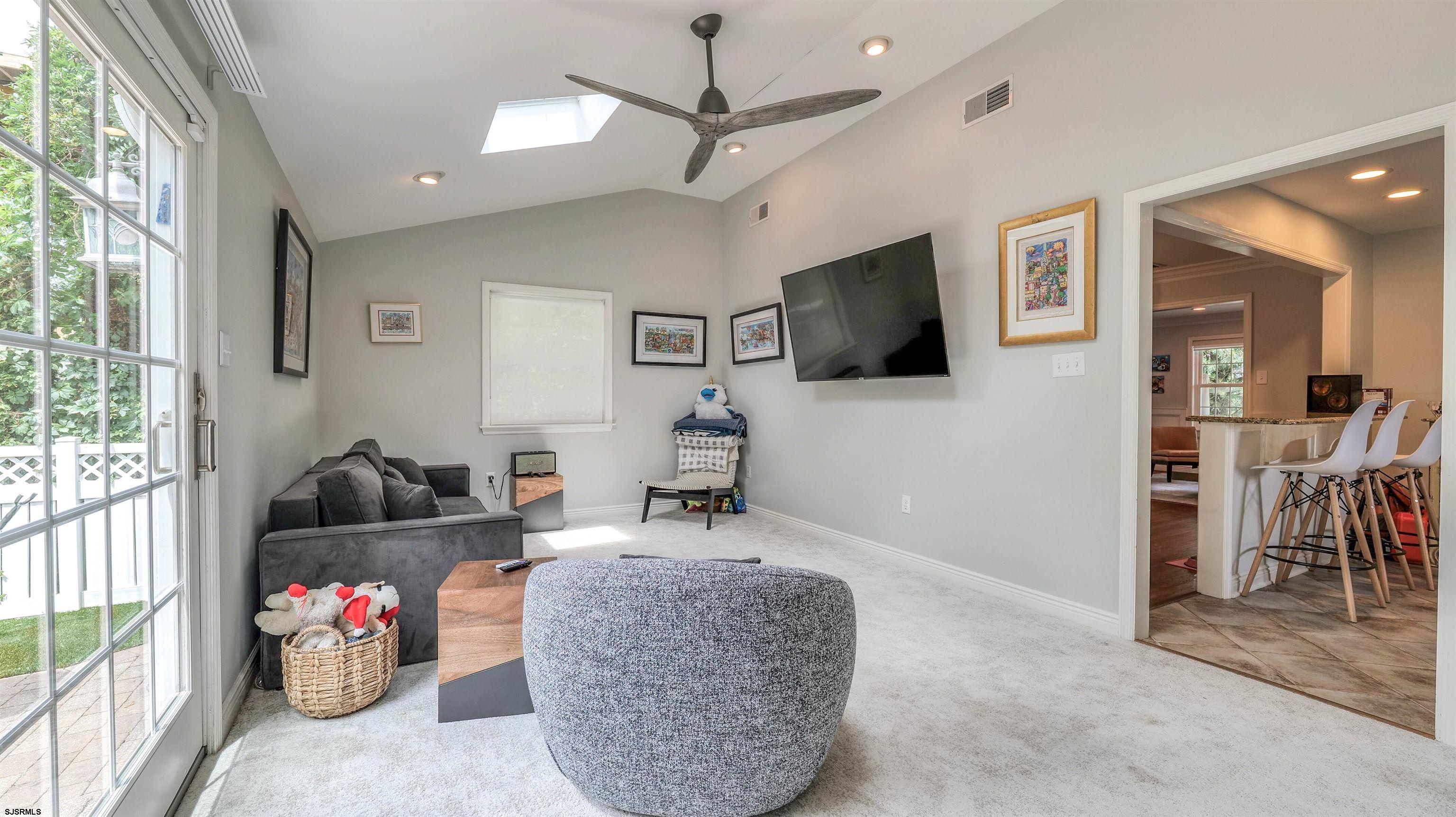 6 North Lancaster Avenue Margate City, NJ 08402 - Photo 17 of 32 a living room with furniture and a flat screen tv