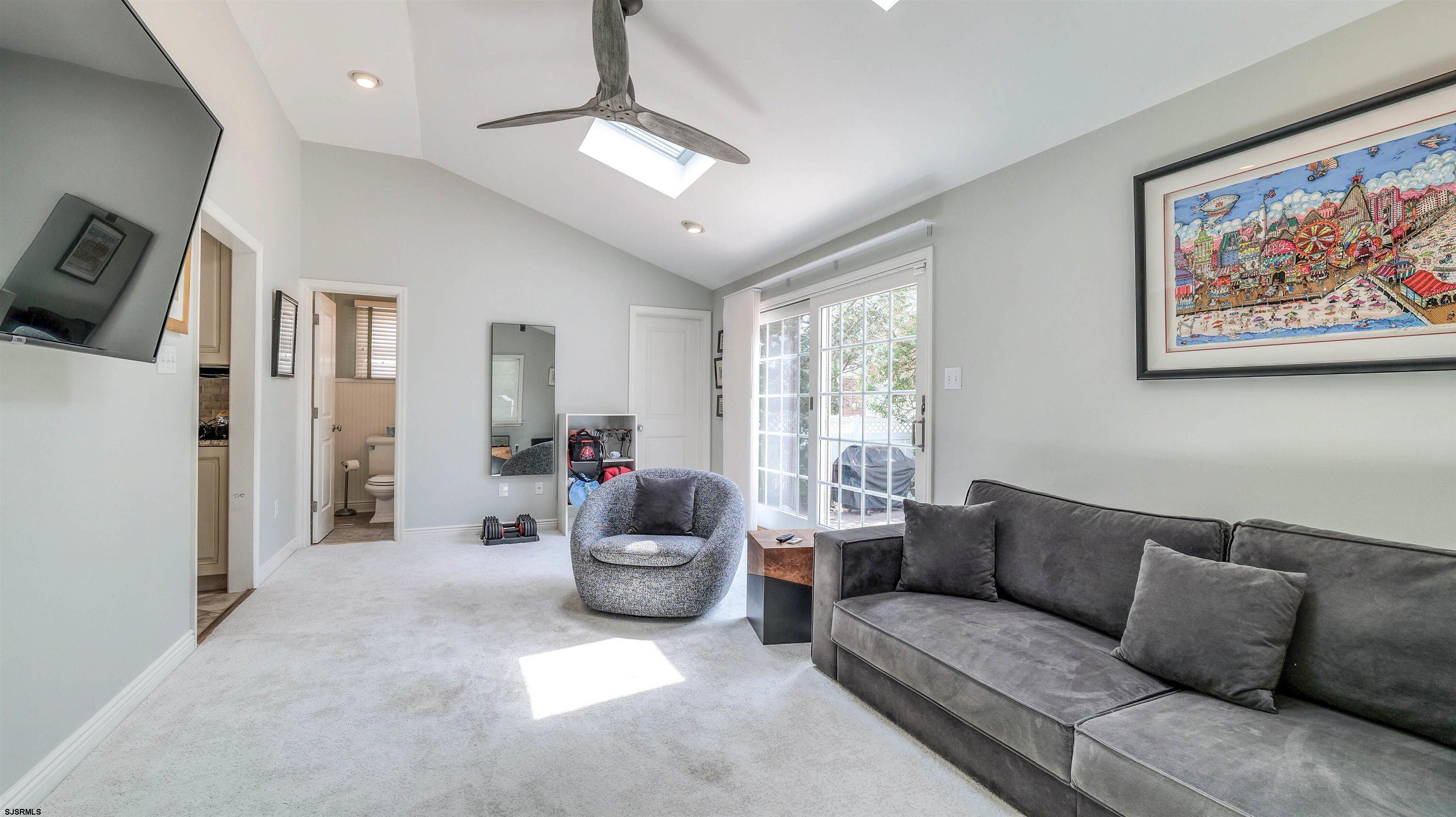 6 North Lancaster Avenue Margate City, NJ 08402 - Photo 18 of 32 a living room with furniture and a chandelier
