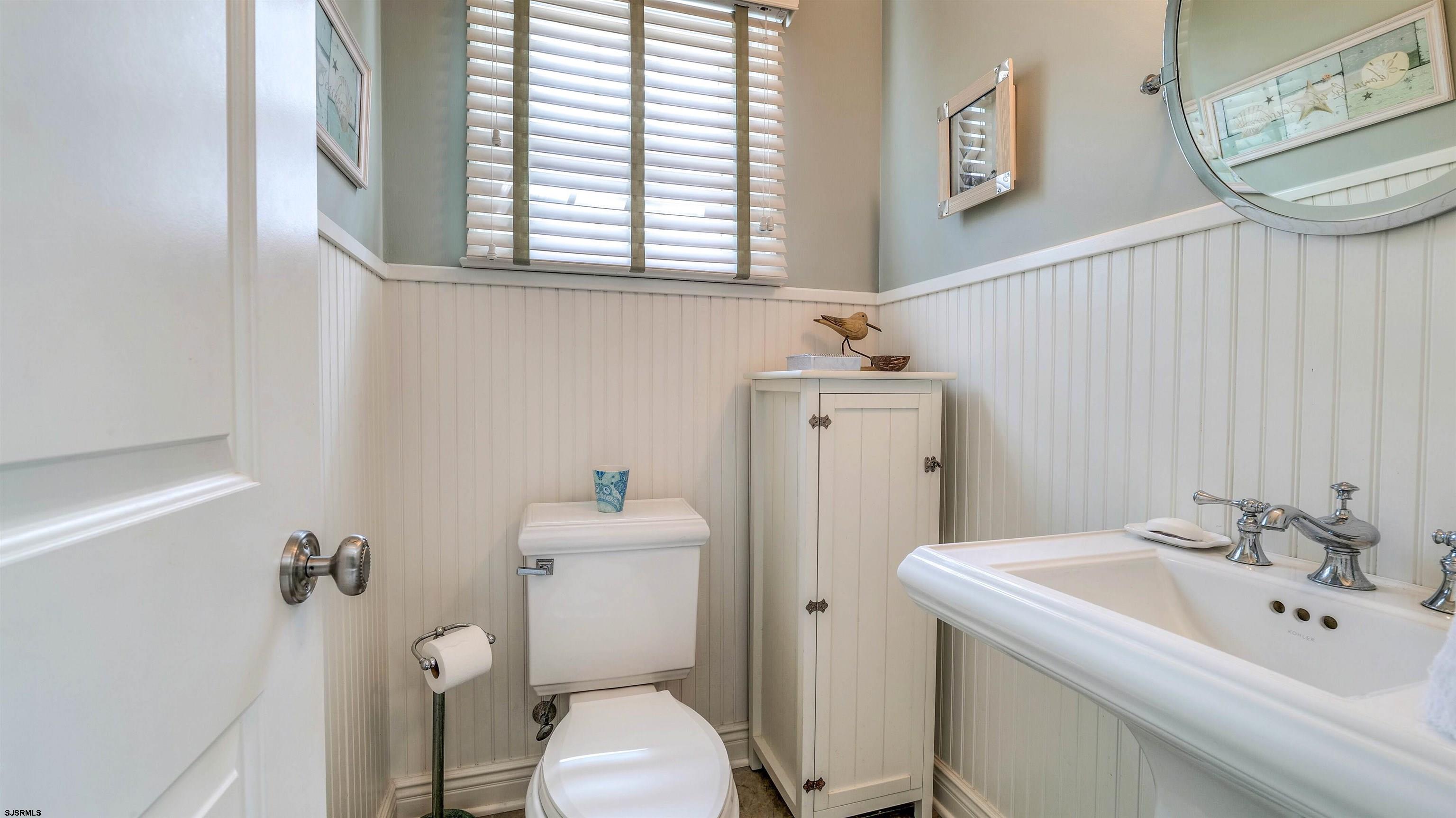 6 North Lancaster Avenue Margate City, NJ 08402 - Photo 19 of 32 a bathroom with a sink a toilet and a mirror