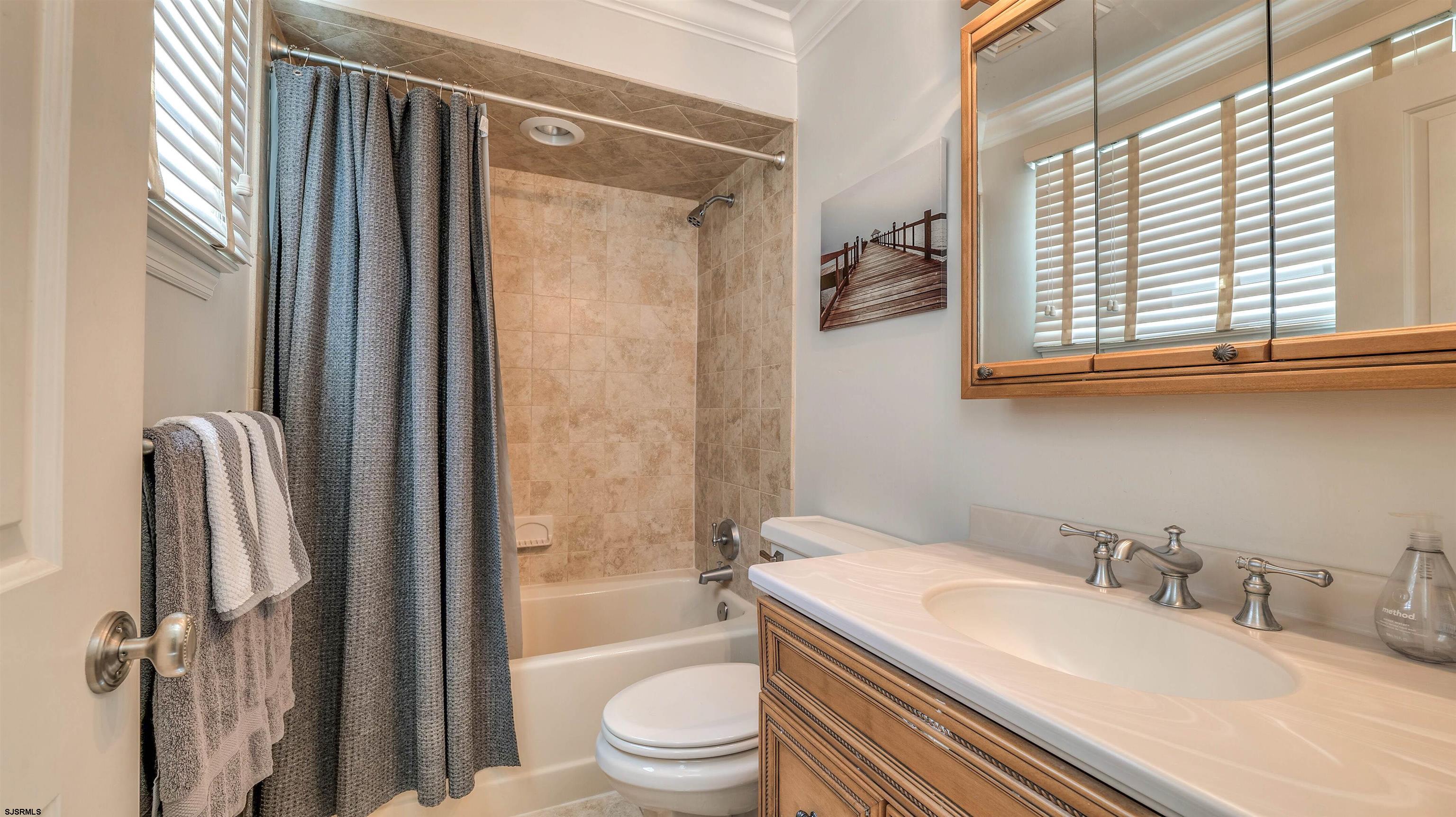 6 North Lancaster Avenue Margate City, NJ 08402 - Photo 20 of 32 a bathroom with a granite countertop sink toilet a mirror and shower