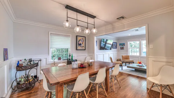 a living room with kitchen island furniture and a chandelier