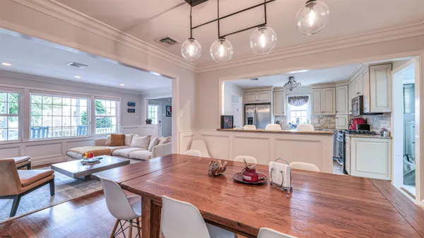 a kitchen with stainless steel appliances granite countertop a stove top oven a sink dishwasher and cabinets with wooden floor