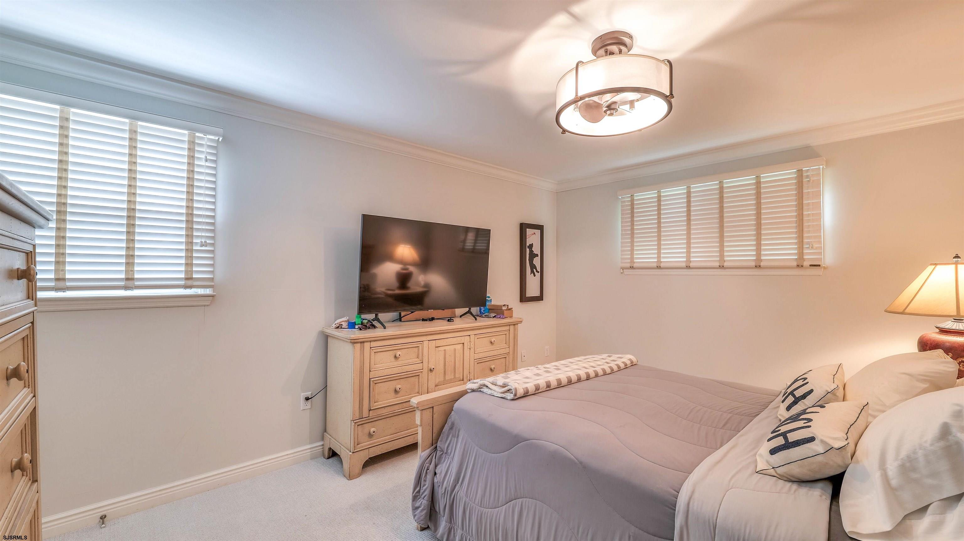 6 North Lancaster Avenue Margate City, NJ 08402 - Photo 22 of 32 a bedroom with a bed and a flat screen tv