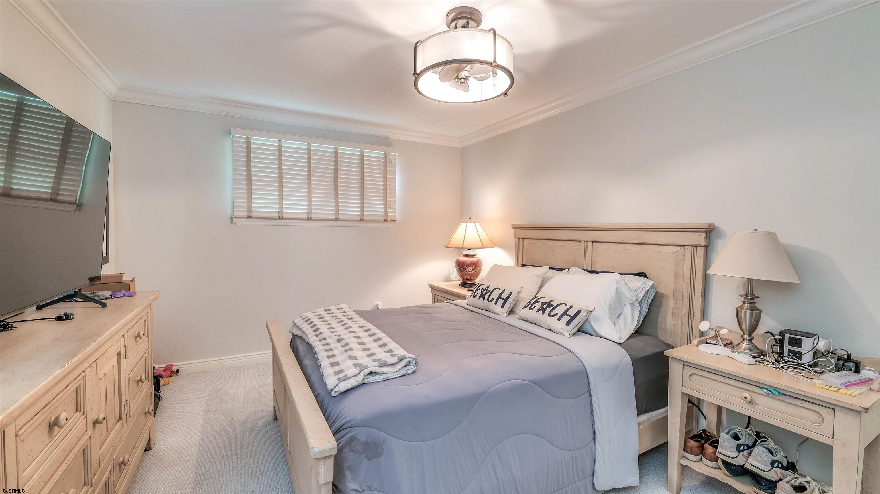 6 North Lancaster Avenue Margate City, NJ 08402 - Photo 23 of 32 a bedroom with a bed and a window