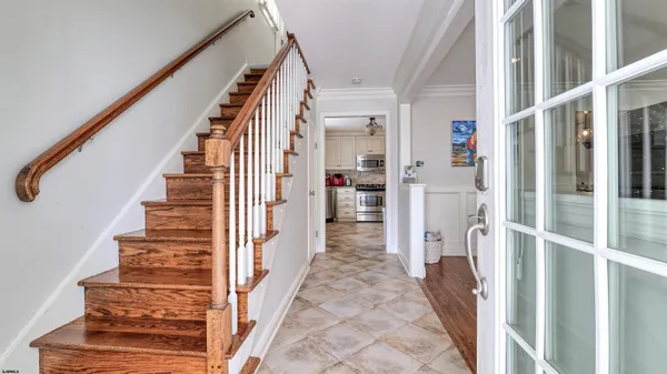 a view of entryway and hall with wooden floor