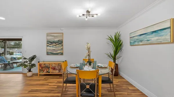 a dining room with furniture and wooden floor