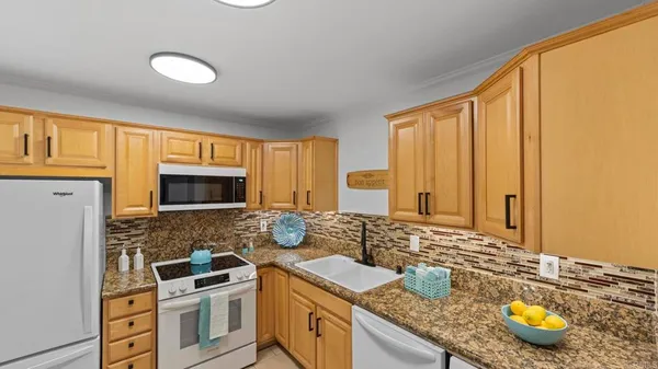 a kitchen with a stove a sink and a microwave