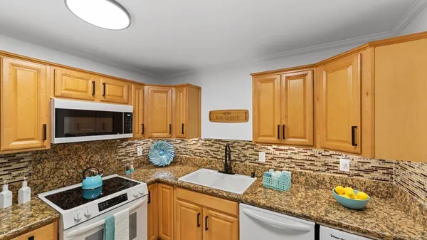 a kitchen with sink cabinets and microwave