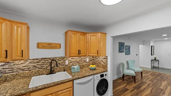 a view of a livingroom with furniture window and wooden floor