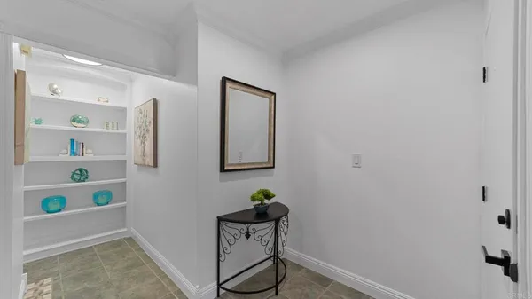 a view of hallway with table and stairs