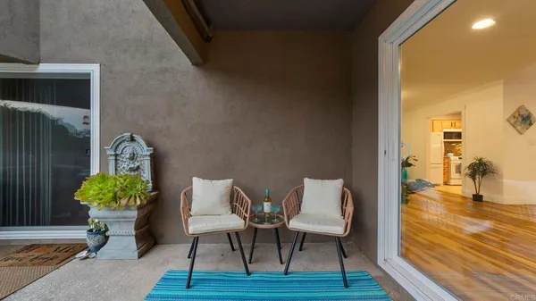 a view of a porch with furniture and a yard