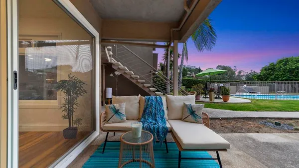 a view of a house with backyard sitting area and garden