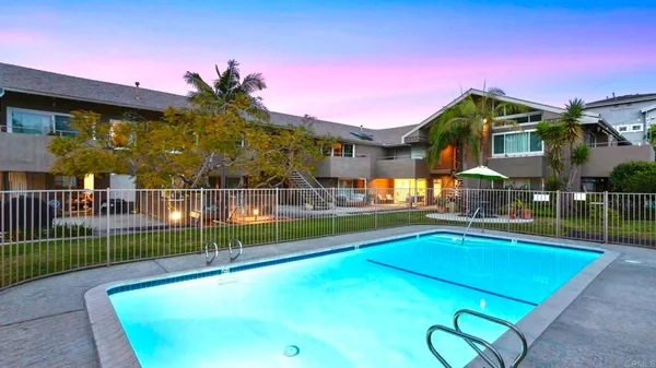 a view of a patio with a table and chairs under an umbrella