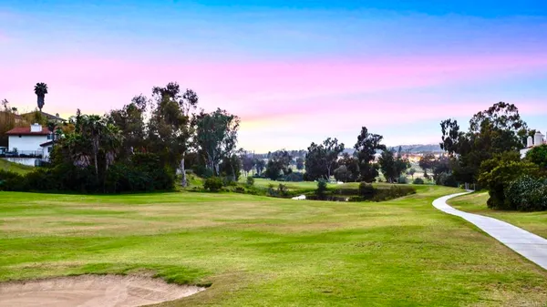 a swimming pool with an outdoor seating and a garden