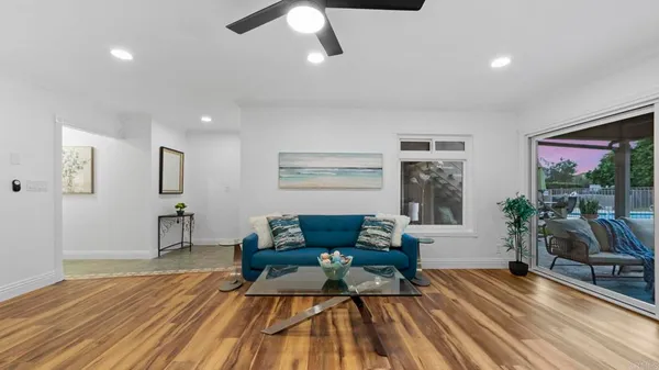 a living room with furniture and wooden floor