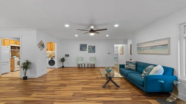 a living room with furniture and wooden floor