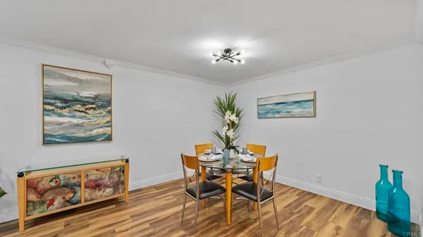 a dining room with furniture and a chandelier