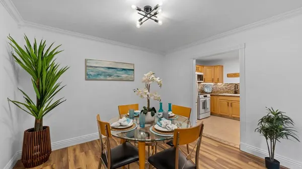 a view of a dining room with furniture and a potted plant