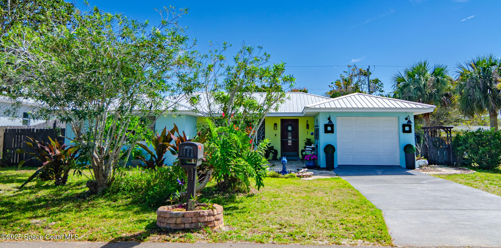 315 Richards Road Melbourne Beach, FL 32951 - Photo 1 of 38 a front view of a house with a yard and potted plants