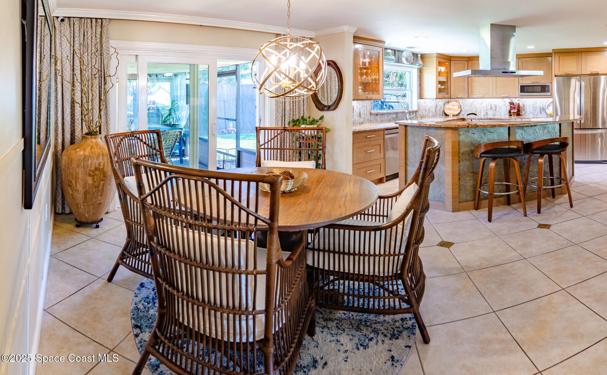 315 Richards Road Melbourne Beach, FL 32951 - Photo 12 of 38 a dining room with furniture a chandelier and wooden floor