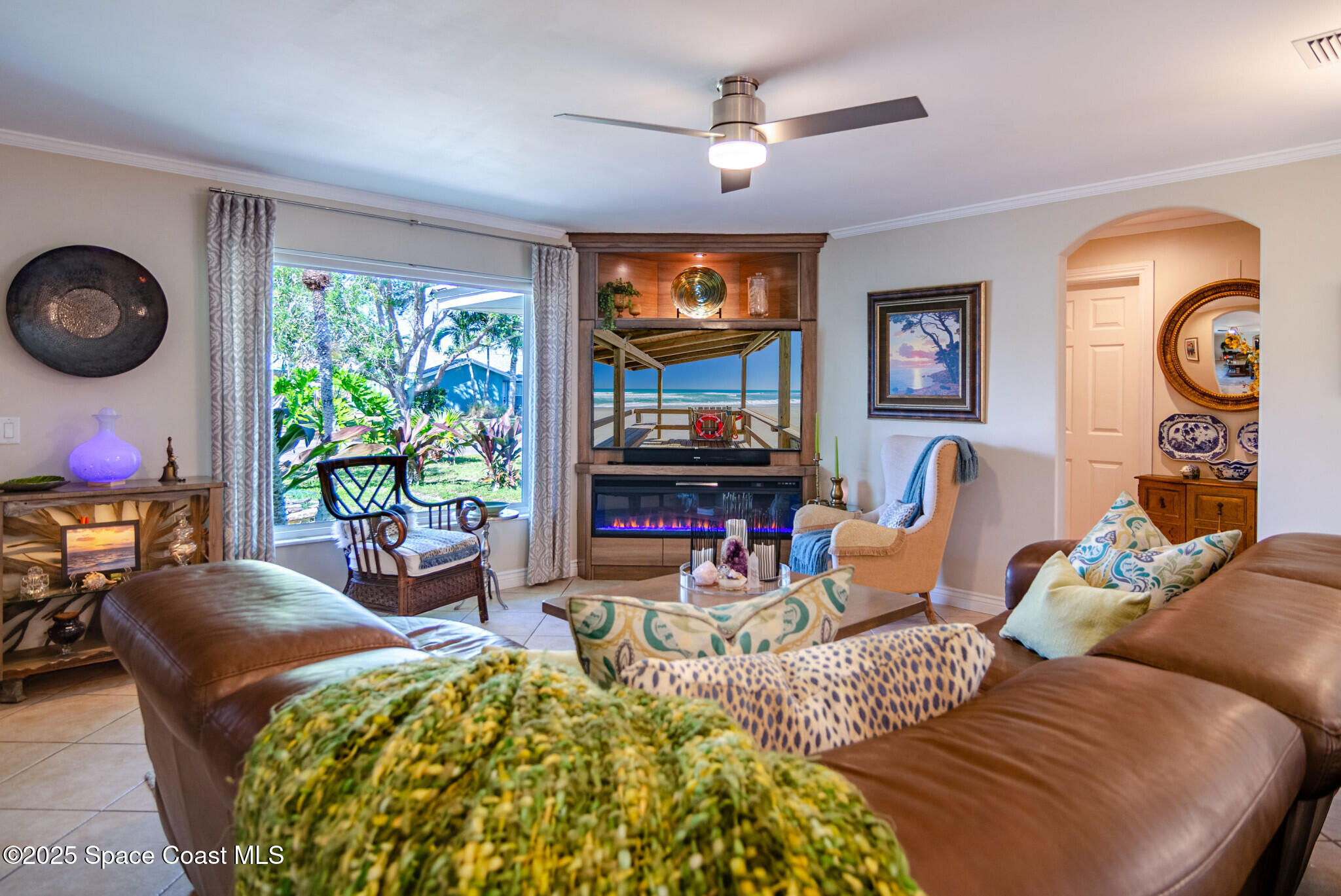 315 Richards Road Melbourne Beach, FL 32951 - Photo 8 of 38 a living room with furniture a flat screen tv and a large window