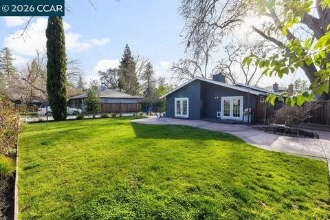 a view of house with yard outdoor seating and entertaining space