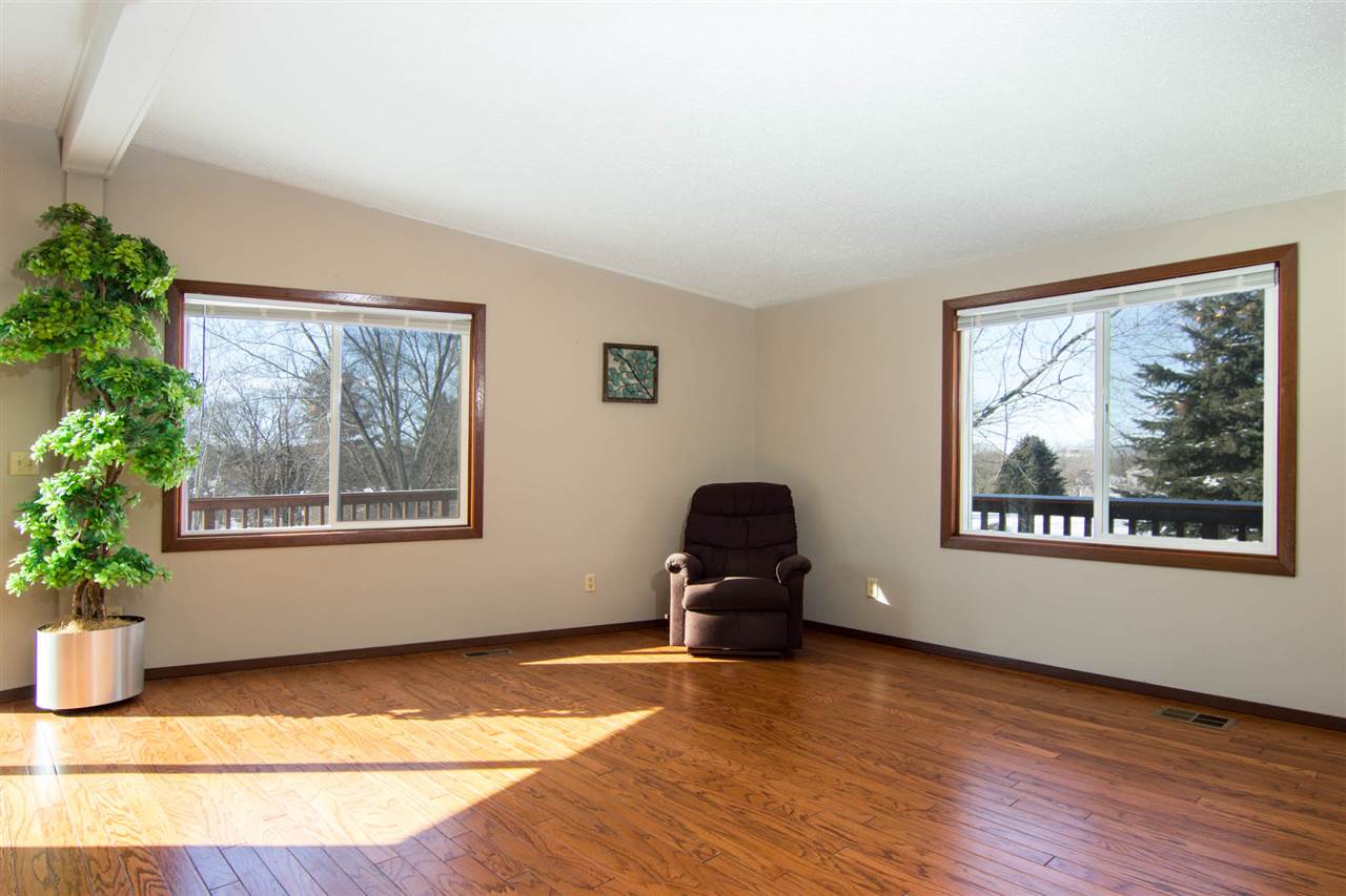 983 Winborne Road Lake Summerset, IL 61019 - Photo 4 of 22 a view of an empty room with a window and wooden floor