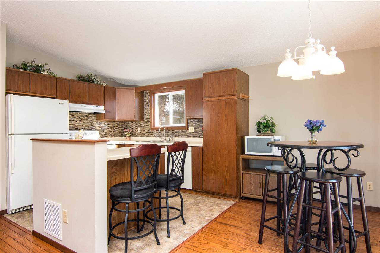 983 Winborne Road Lake Summerset, IL 61019 - Photo 5 of 22 a kitchen with stainless steel appliances granite countertop a dining table chairs and a refrigerator