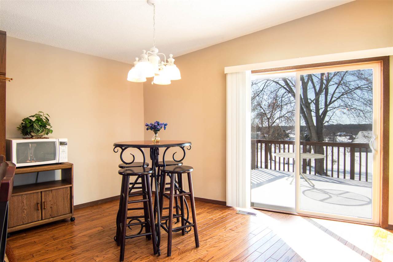 983 Winborne Road Lake Summerset, IL 61019 - Photo 7 of 22 a view of a dining room with furniture wooden floor and a chandelier