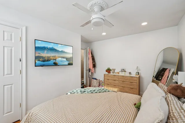 a bedroom with a bed and a painting on the wall