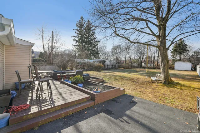 a view of yard with tree in the background