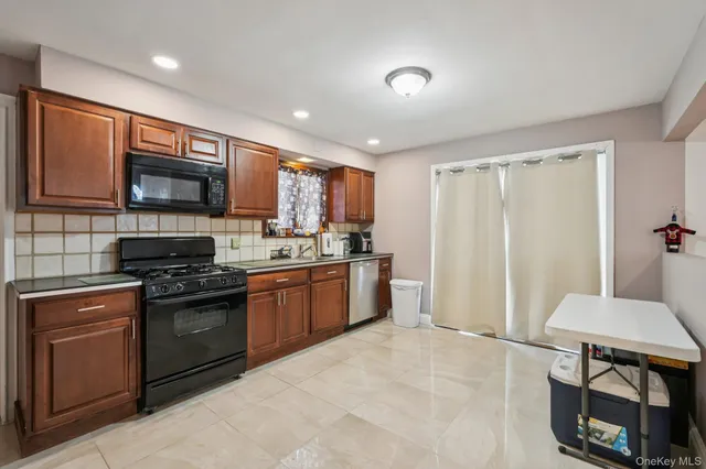 a kitchen with stainless steel appliances granite countertop a stove refrigerator sink and cabinets