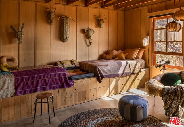 a bedroom with bed and wooden floor
