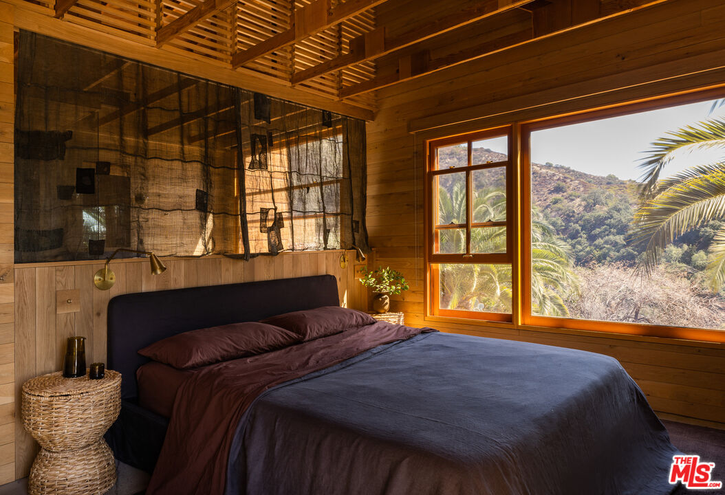 4610 Rising Hill Road Altadena, CA 91001 - Photo 16 of 26 a bedroom with a bed and a large window