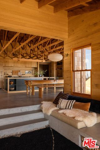 a living room with furniture and a floor to ceiling window
