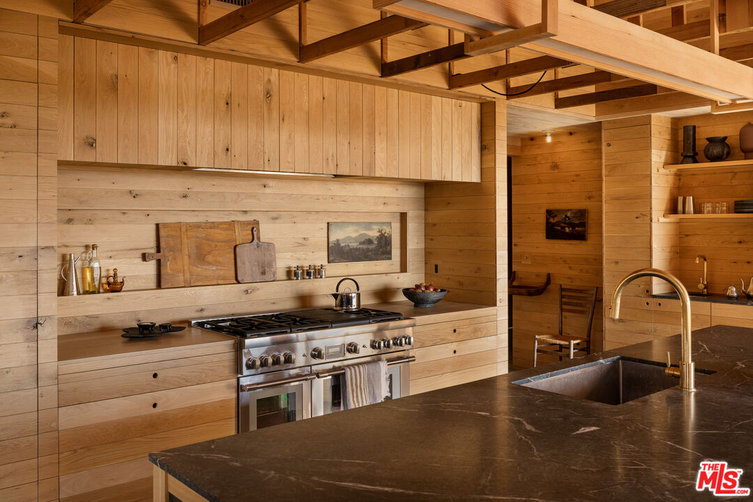 4610 Rising Hill Road Altadena, CA 91001 - Photo 8 of 26 a kitchen with stainless steel appliances granite countertop a sink stove and cabinets