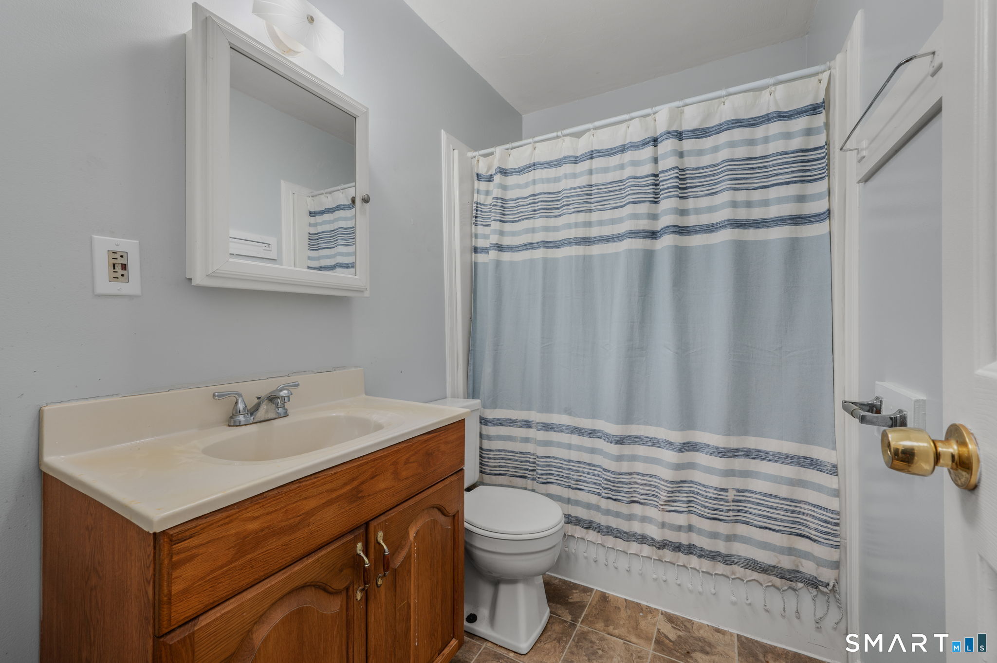 275 Midway Ovl Groton, CT 06340 - Photo 18 of 21 a bathroom with a sink a toilet and shower curtain
