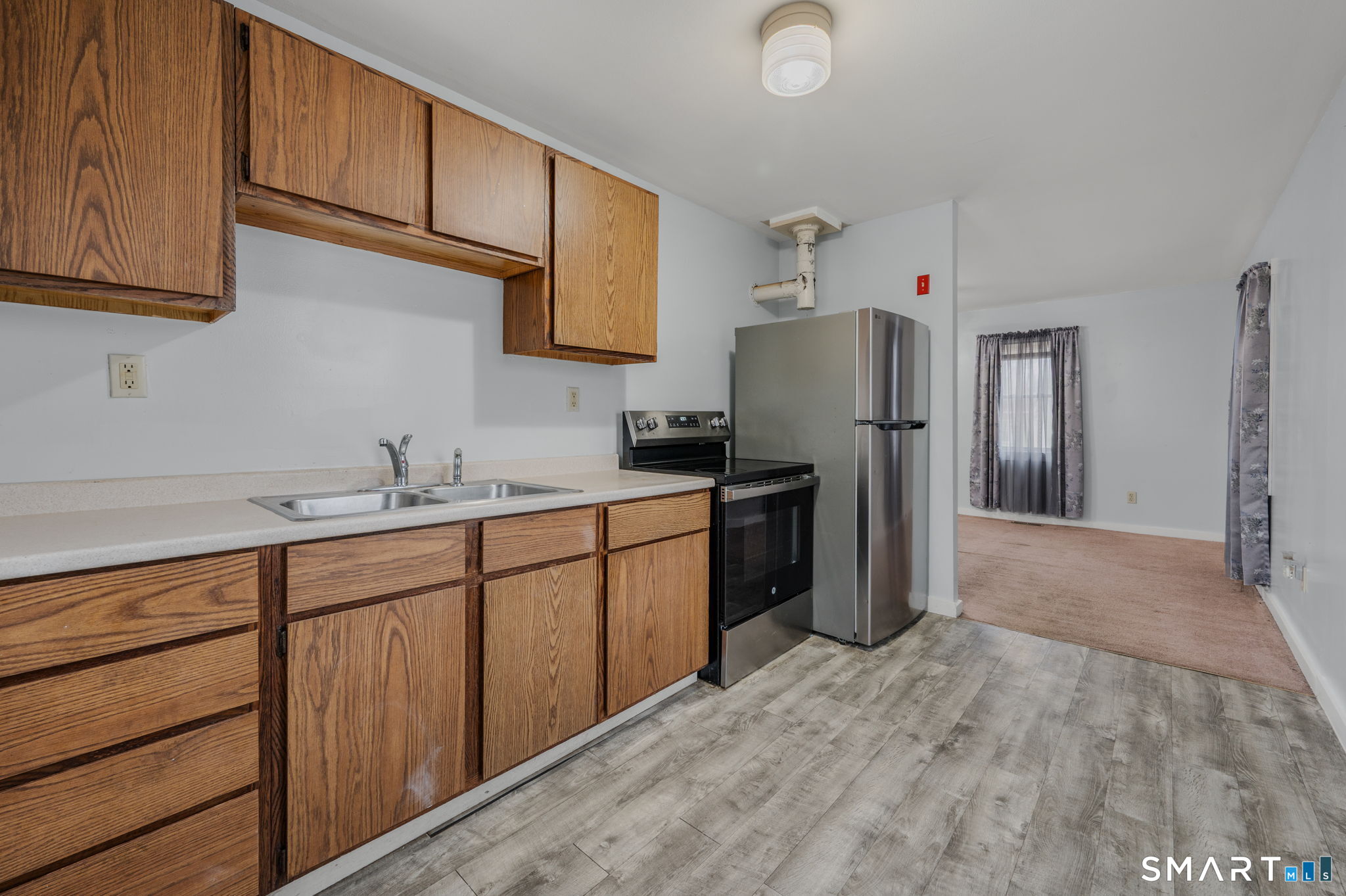 275 Midway Ovl Groton, CT 06340 - Photo 3 of 21 a kitchen with stainless steel appliances granite countertop a refrigerator sink and cabinets