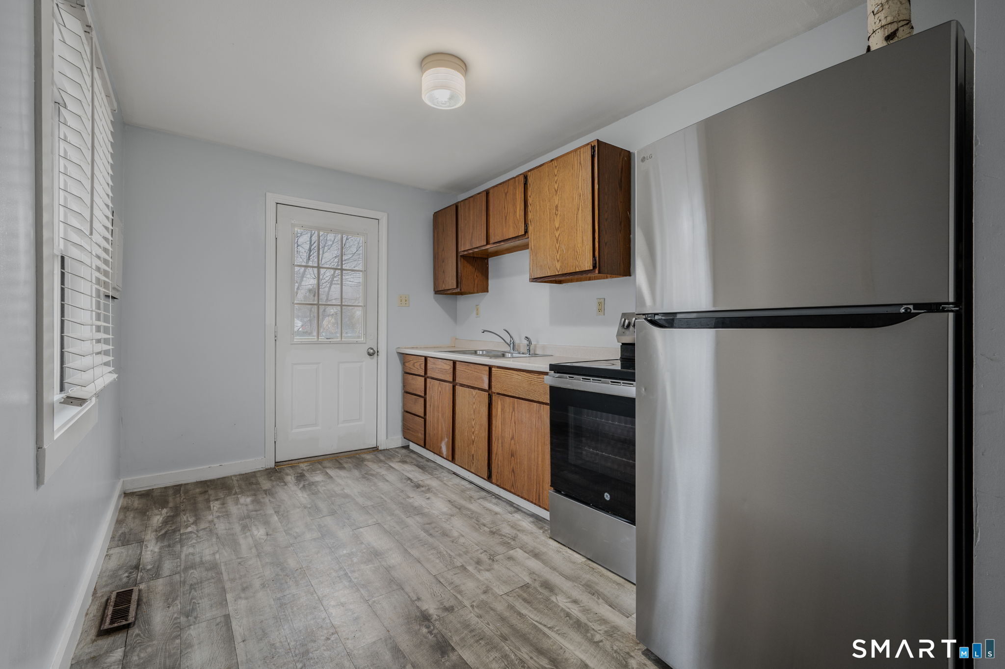 275 Midway Ovl Groton, CT 06340 - Photo 4 of 21 a kitchen with a refrigerator and a sink