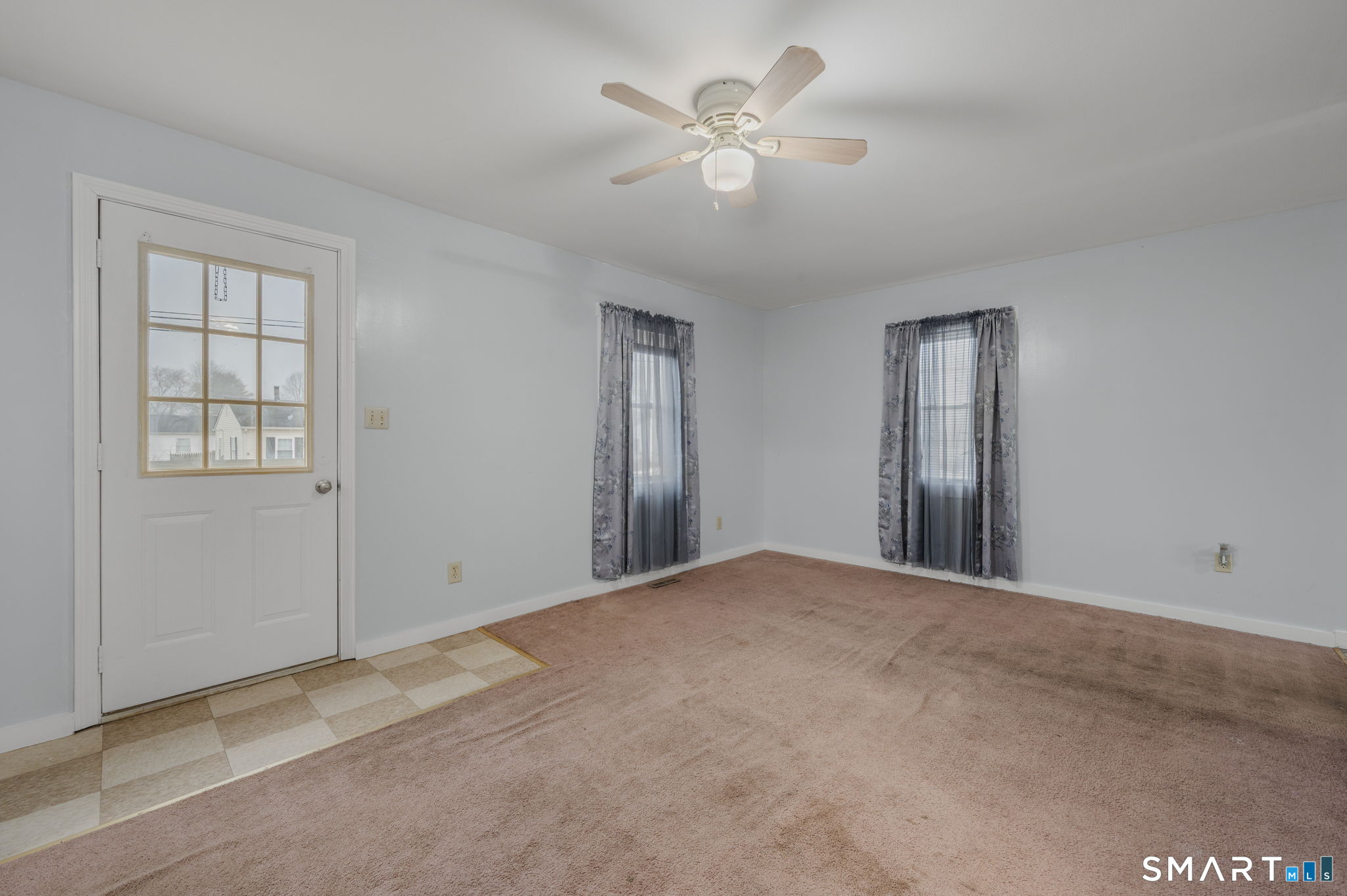 275 Midway Ovl Groton, CT 06340 - Photo 9 of 21 an empty room with windows and fan