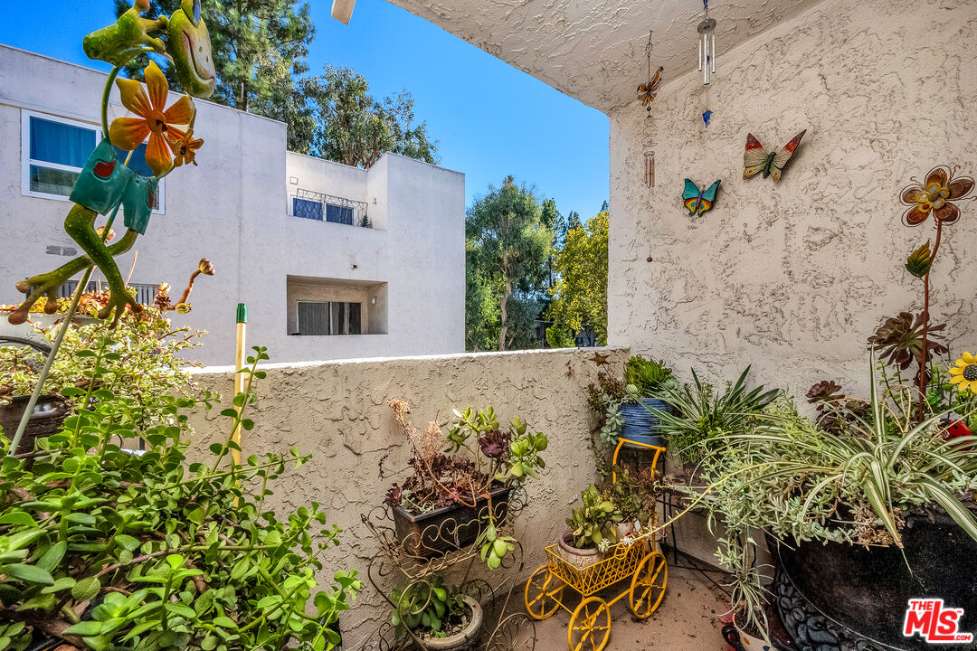 18411 Hatteras Street, Unit 114 Tarzana, CA 91356 - Photo 14 of 19 an aerial view of a house with a yard and large trees