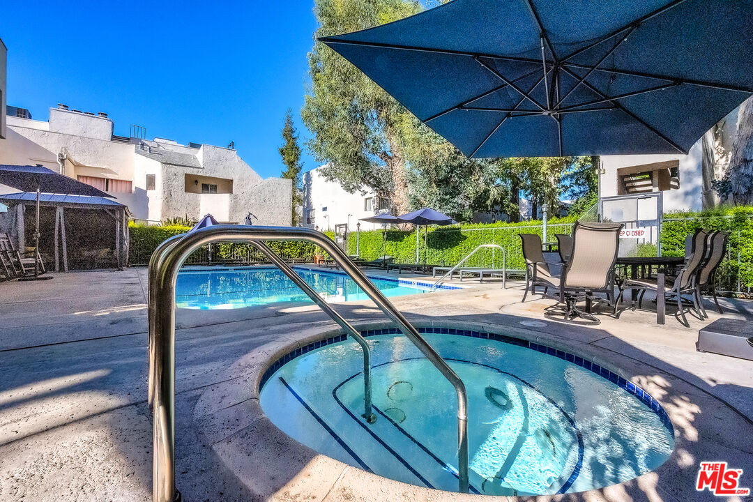 18411 Hatteras Street, Unit 114 Tarzana, CA 91356 - Photo 17 of 19 a view of swimming pool with outdoor seating